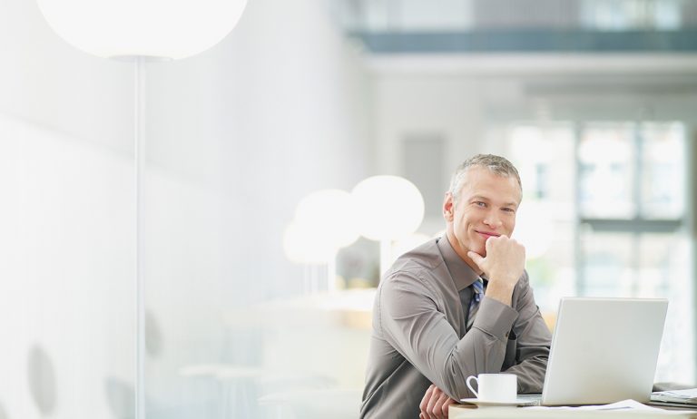 Businessman working on laptop in cafe